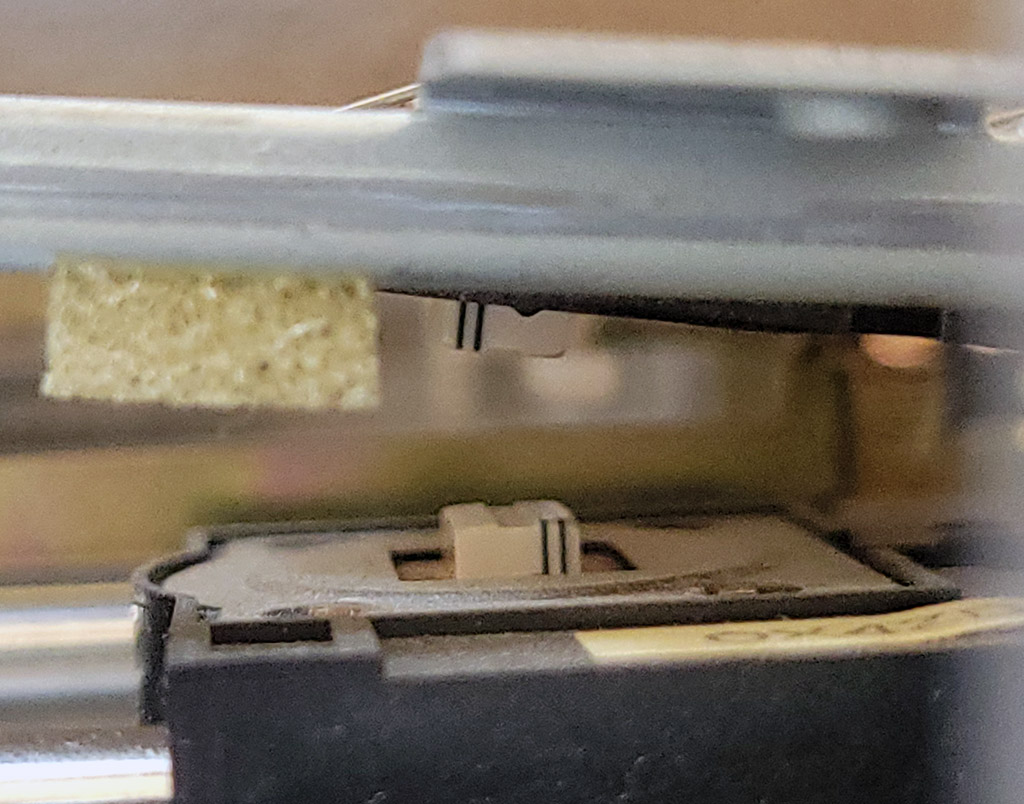 A photograph of the opposing heads of a double-sided floppy drive